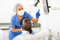 Man patient and woman dentist looking at monitor during consultation Royalty Free Stock Photo