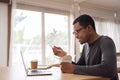 African American man making video call and eating instant cup noodle with chopstick Royalty Free Stock Photo