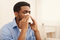 African-american man man has runny nose at home Royalty Free Stock Photo