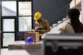 African american man packing customer package in postal warehouse Royalty Free Stock Photo