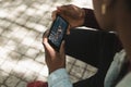 African american man in park watching woman weightlifting on smartphone