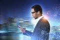 African American man with a phone, blurred city Royalty Free Stock Photo