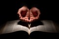 African American Man Praying with Hands Open on Top of the Bible Royalty Free Stock Photo