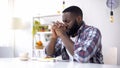 African-American man praying before lunch, thanking God for meal, religion Royalty Free Stock Photo