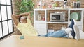 African american man relaxed with hands on head sitting on table at dinning room Royalty Free Stock Photo