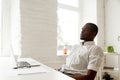 African-american man relaxing after work breathing air in home o