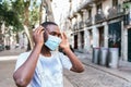 young african man removing his face mask in the streets of Barcelona Royalty Free Stock Photo