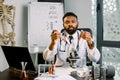 African-american man scientist doctor working in lab making medical research, using laboratory tools, microscope, test Royalty Free Stock Photo