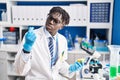 African american man scientist holding pill and lemon at laboratory Royalty Free Stock Photo