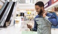 African american man with shopping bags using cellphone Royalty Free Stock Photo