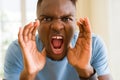 African american man shouting with rage, yelling excited with hand on mouth Royalty Free Stock Photo