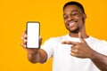 African American Man Showing Mobile Phone Screen, Yellow Background, Mockup