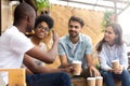 African American man showing thumb up to friends in cafe Royalty Free Stock Photo