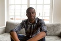 African American man sit on couch making video call