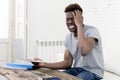 African american man sitting at home living room working with laptop computer and paperwork Royalty Free Stock Photo