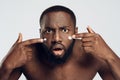 African American man is smeared with face cream. Royalty Free Stock Photo
