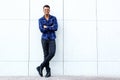 African american man smiling against wall with arms crossed Royalty Free Stock Photo