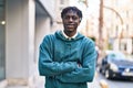 African american man standing with arms crossed gesture at street Royalty Free Stock Photo