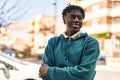 African american man standing with arms crossed gesture at street Royalty Free Stock Photo