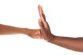 African American man stopping woman`s fist on white background, closeup. Antiracism concept