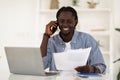 African American Man Talking On Cellphone And Working With Papers At Office Royalty Free Stock Photo