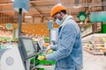 African-American man touches screen of self-checkout point Royalty Free Stock Photo