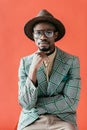 African American Man In Trendy Eyeglasses And Hat Posing For Vintage Fashion Shoot,