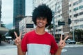African american man with typical afro hair showing victory sign Royalty Free Stock Photo