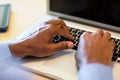 African American man at typing on a computer.