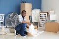 African-American man unpacking box indoors. Moving into new house Royalty Free Stock Photo