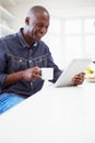 African American Man Using Digital Tablet At Home Royalty Free Stock Photo