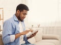 African-american man using digital tablet at home Royalty Free Stock Photo