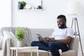 African-american man using digital tablet at home Royalty Free Stock Photo