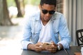 Man using his mobile phone at coffee shop. Royalty Free Stock Photo