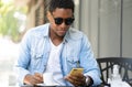 Man using his mobile phone at coffee shop. Royalty Free Stock Photo