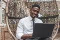 African american man using laptop at outdoors cafe Royalty Free Stock Photo