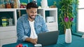 African american man using laptop sitting on table having idea at dinning room Royalty Free Stock Photo