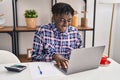 African american man using laptop sitting on table at home Royalty Free Stock Photo