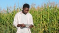 African American man walks past field examining plantation