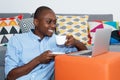 African american man watching movie clip online with laptop Royalty Free Stock Photo