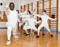 African American wearing fencing uniform practicing with foil