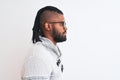 African american man wearing grey sweater and glasses over isolated white background looking to side, relax profile pose with Royalty Free Stock Photo