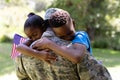 African American man wearing a military uniform holding his children Royalty Free Stock Photo