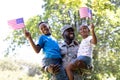 African American man wearing a military uniform holding his children Royalty Free Stock Photo