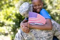 African American man wearing a military uniform holding his son Royalty Free Stock Photo