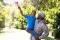 African American man wearing a military uniform holding his son Royalty Free Stock Photo