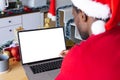 African american man wearing santa hat, using laptop with copyspace Royalty Free Stock Photo