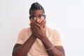 African american man wearing striped t-shirt and glasses over isolated white background shocked covering mouth with hands for Royalty Free Stock Photo