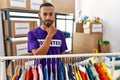 African american man wearing volunteer t shirt at donations stand looking confident at the camera with smile with crossed arms and Royalty Free Stock Photo