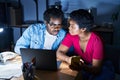 African american man and woman business workers using laptop and smartphone at office